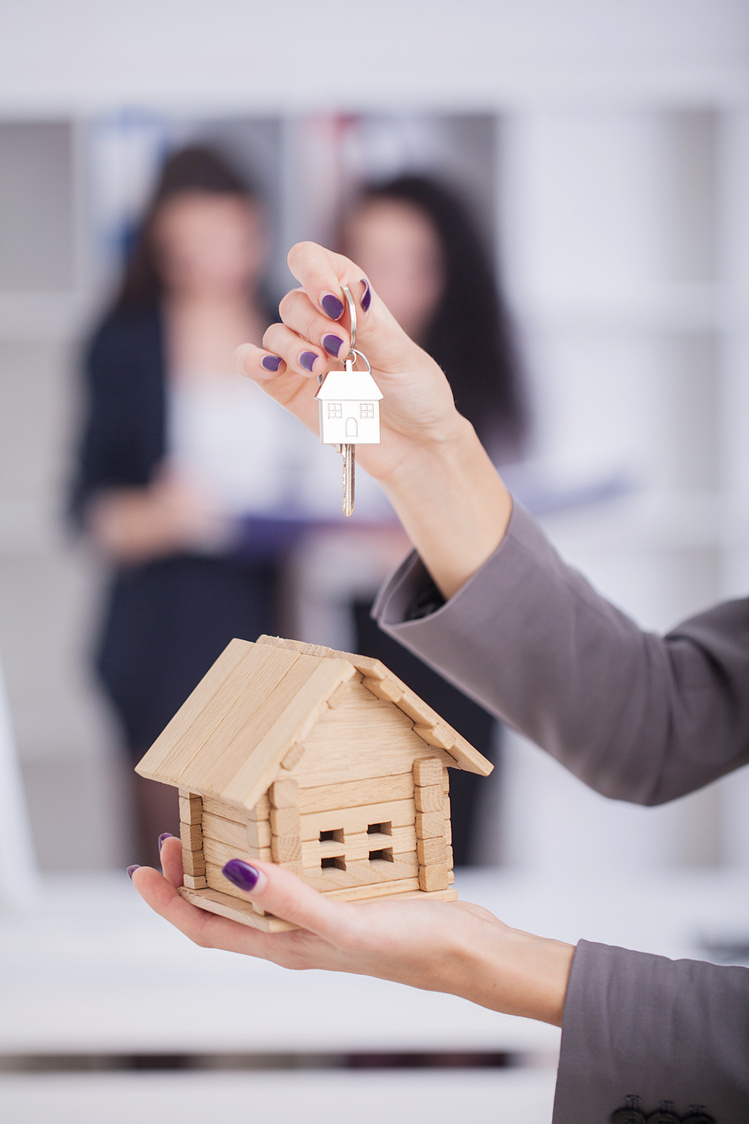 Real Estate Agent Giving House Keys to a Customer